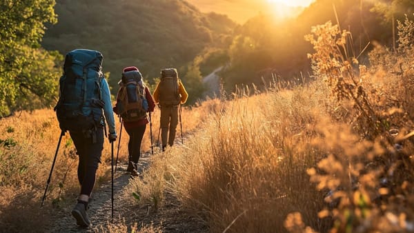 £ hikers walking into the distant sunlight.